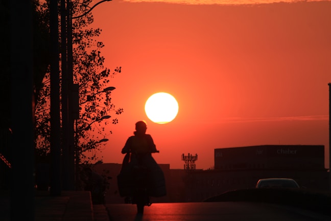 Outdoor shot of someone biking at sunset while wearing Lumina activewear, highlighting movement and comfort.
