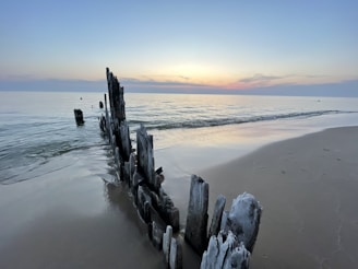 Beautiful beach scene near Côn Đảo at sunset with calm waves and pastel skies