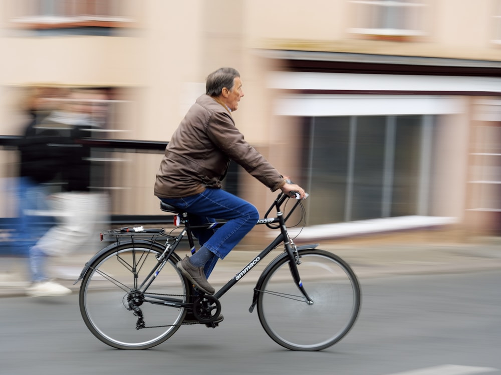 a man riding a bike down a street