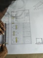 a person is drawing a floor plan on a piece of paper