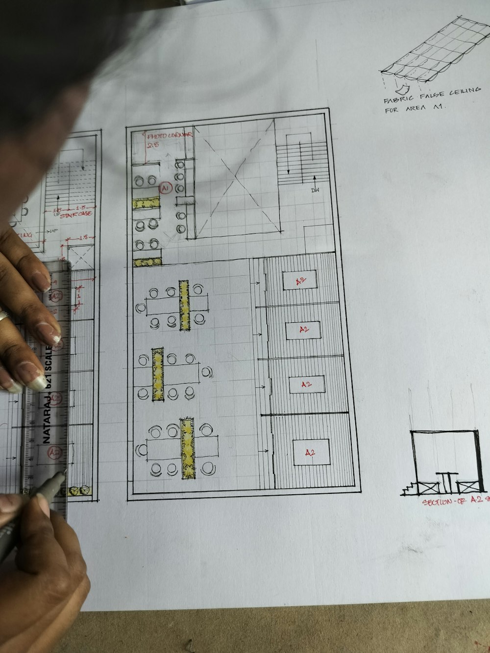a person is drawing a floor plan on a piece of paper