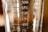 A close-up view of a transparent measuring container with measurement markings ranging from 75 to 200 milliliters. The surface of the container appears reflective with some light and shadow play.