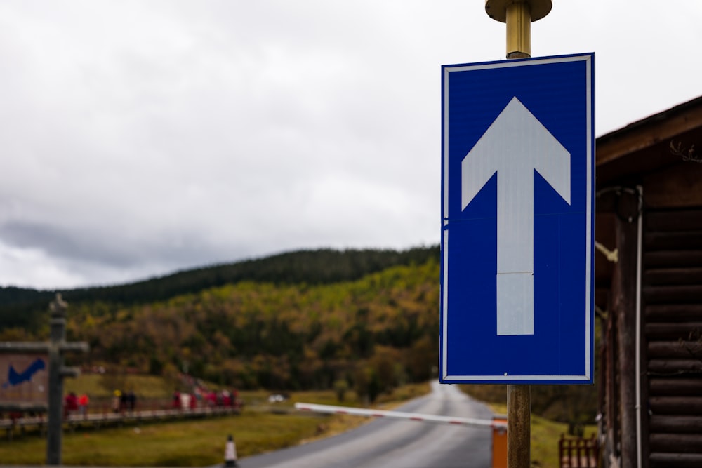 a blue sign with an arrow pointing to the right