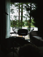 Terrace view at dusk with smooth fade-in lighting and minimalist furniture in bone white tones.
