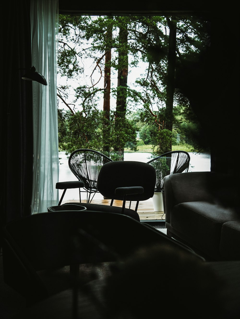 a living room filled with furniture next to a window