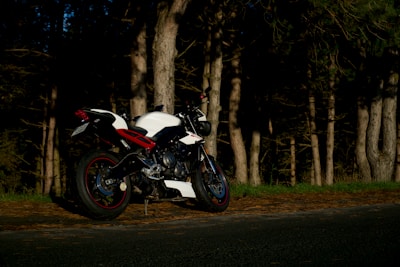 A sleek motorcycle parked by the roadside, ready for a quick, efficient trip.