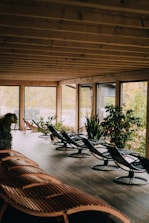 Elegant clubhouse area surrounded by natural greenery with comfortable seating spaces.