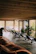 A peaceful waiting area with wooden furniture and green leafy decor.