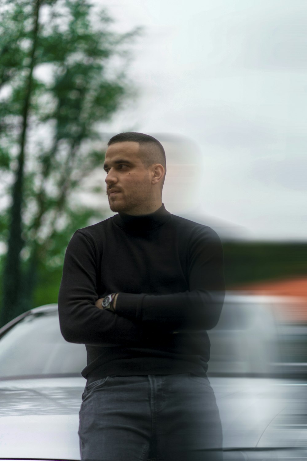 a man is standing in front of a car