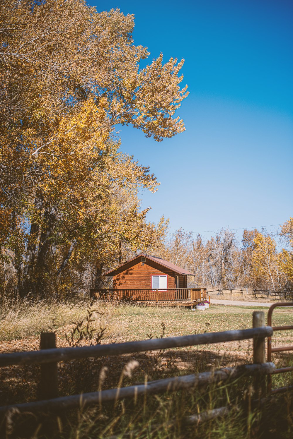 a log cabin in the middle of a field