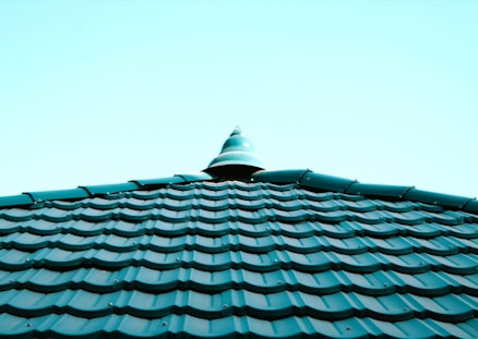 a close up of a roof with a blue sky in the background