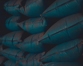 Close-up of sturdy big bags stacked neatly in a factory setting.