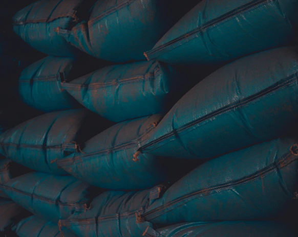 Close-up of durable big bags stacked neatly in a warehouse.
