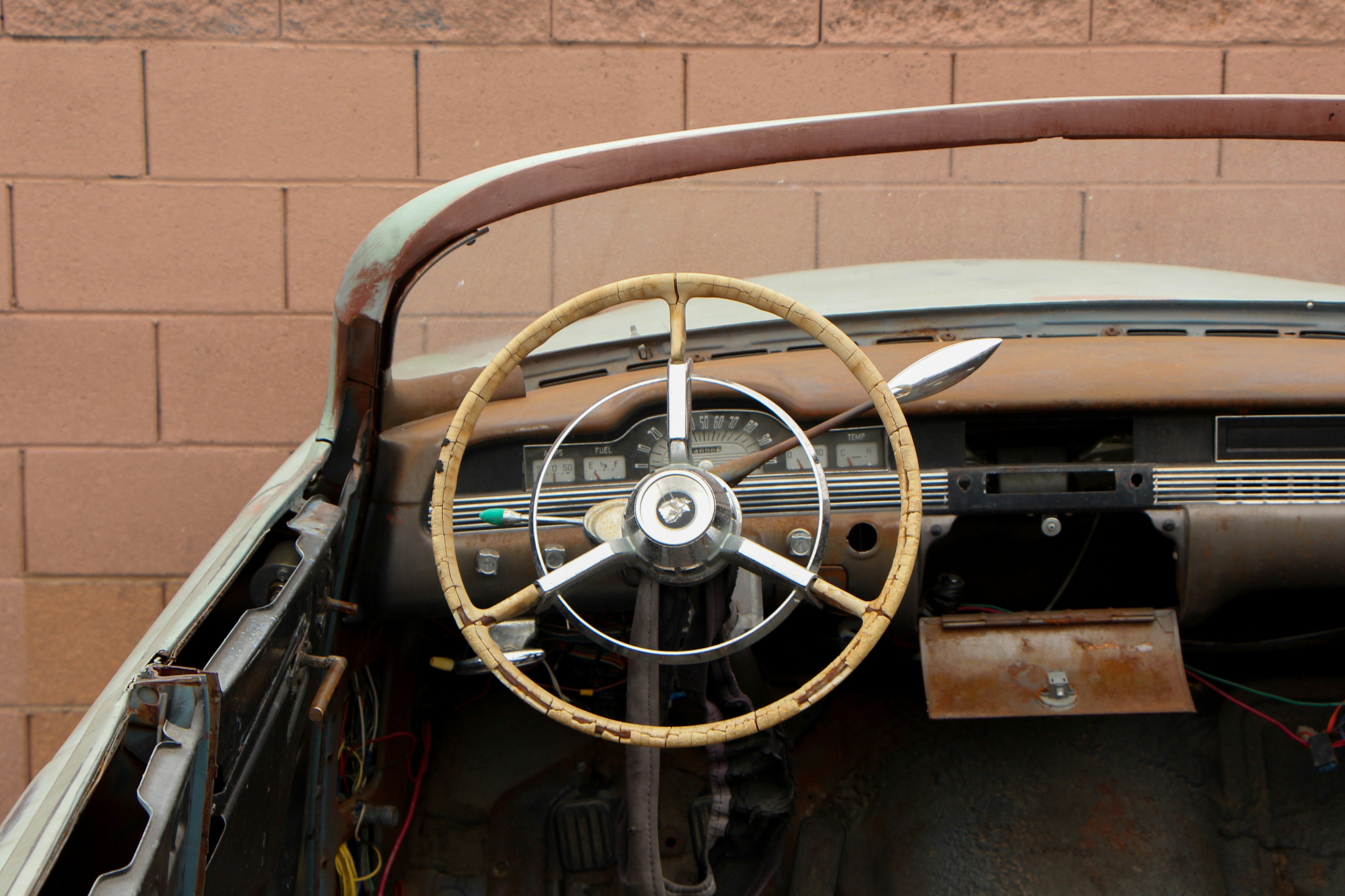 the interior of an old car with a steering wheel