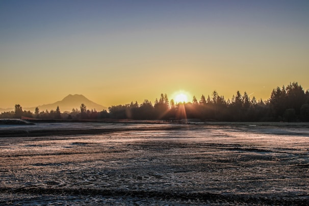 An inspirational image depicting a serene landscape with a sunrise.
