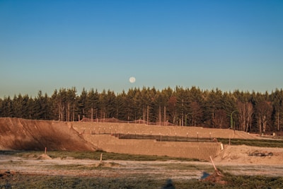 A serene landscape with a construction site in the background, symbolizing growth and progress.