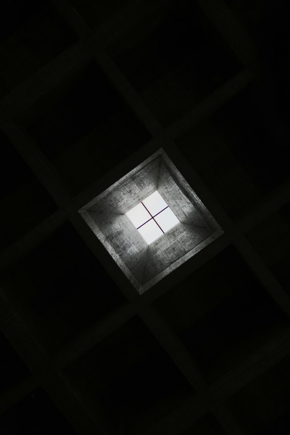 a dark room with a square window in the middle