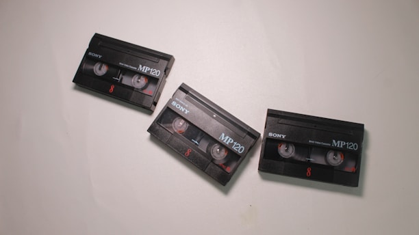 Three Sony MP120 Video8 cassette tapes are arranged on a light surface, each displaying the Sony brand and MP120 label prominently. The tapes feature visible spools and numbered markings in red.