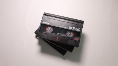 Close-up of old VHS tapes lined up, ready for digital transfer.