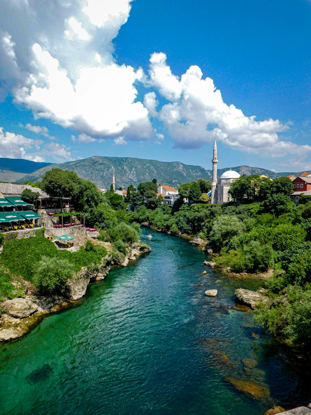 a river running through a lush green countryside