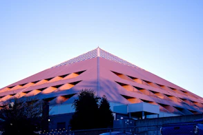 a tall pink building with a sky background