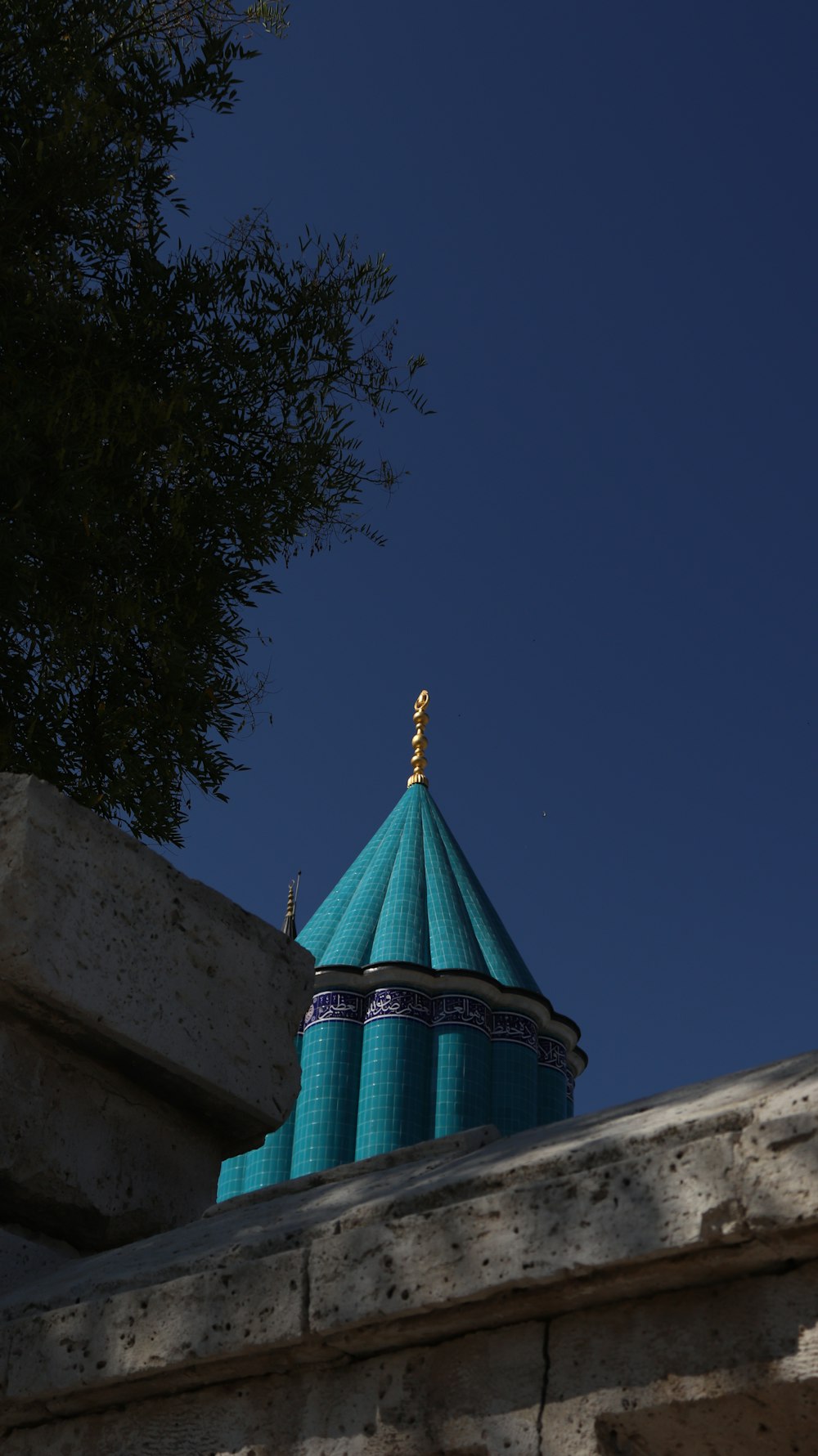 a blue dome on top of a stone wall