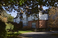 An exterior shot of a beautiful house with landscaped gardens.