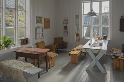 A cozy room with classic wooden furniture and a balcony facing the harbor.