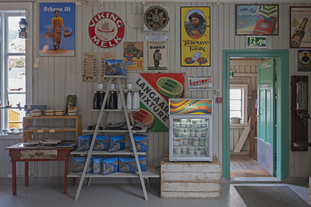 a room filled with lots of posters and a ladder