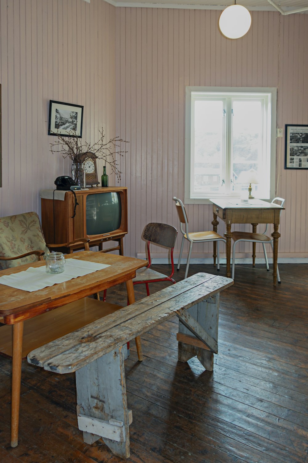 a room with a wooden table and a bench