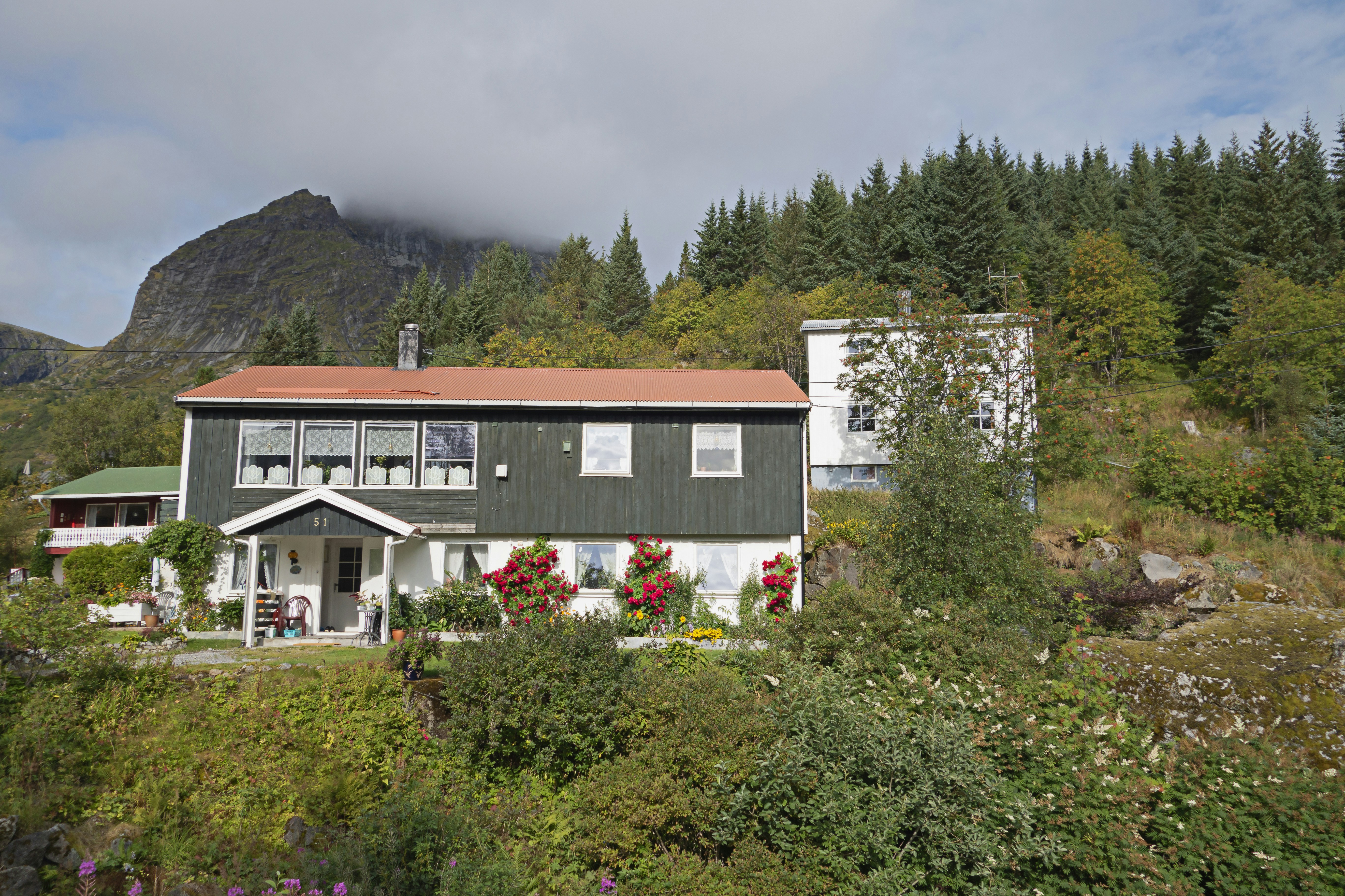 a house on a hill with a mountain in the background, 