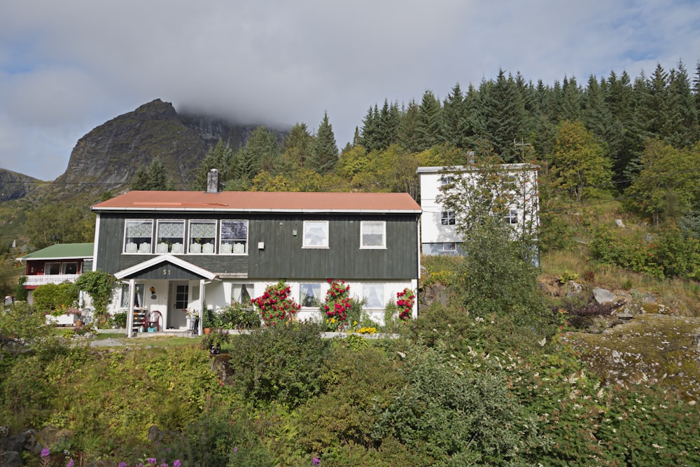 a house on a hill with a mountain in the background