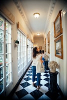 A companion walking along a modern art gallery hallway, showcasing sophistication and grace.