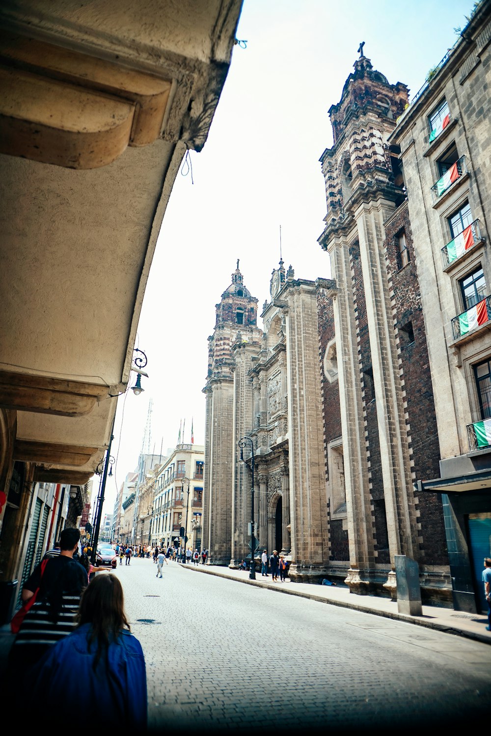 a city street lined with tall buildings next to tall buildings