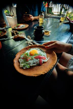 a person holding a plate with food on it
