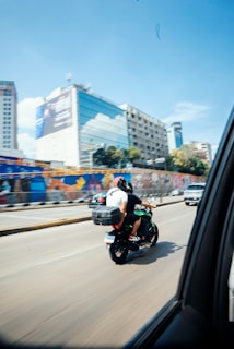 a man riding a motorcycle down a street
