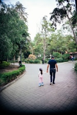 A happy family enjoying roller skating together in a sunny park