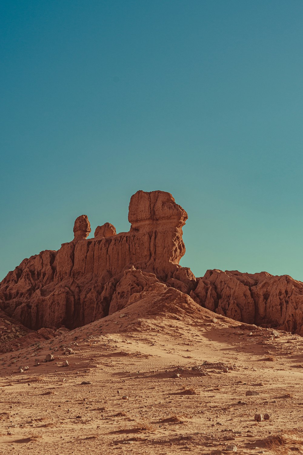 a large rock formation in the middle of a desert