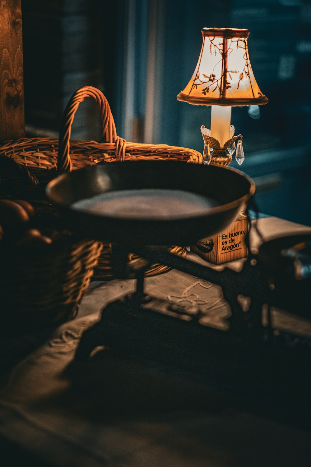 a basket and a lamp on a table