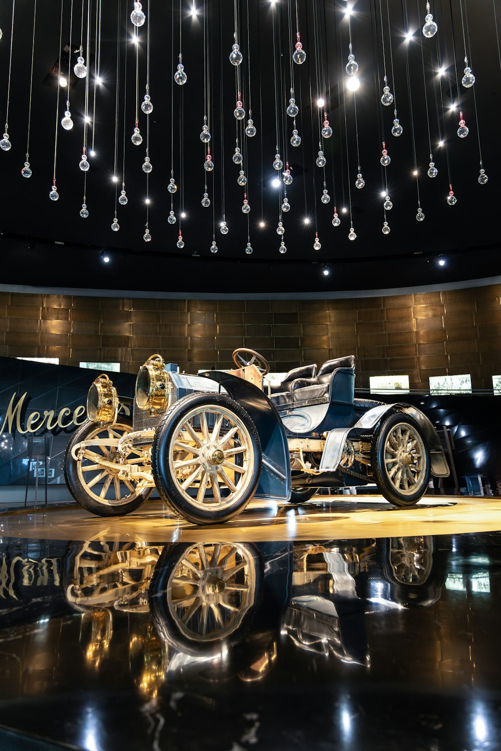 a car on display in a building with chandelier