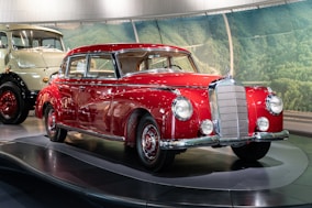 a red and white car on display in a museum