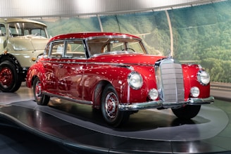 a red and white car on display in a museum