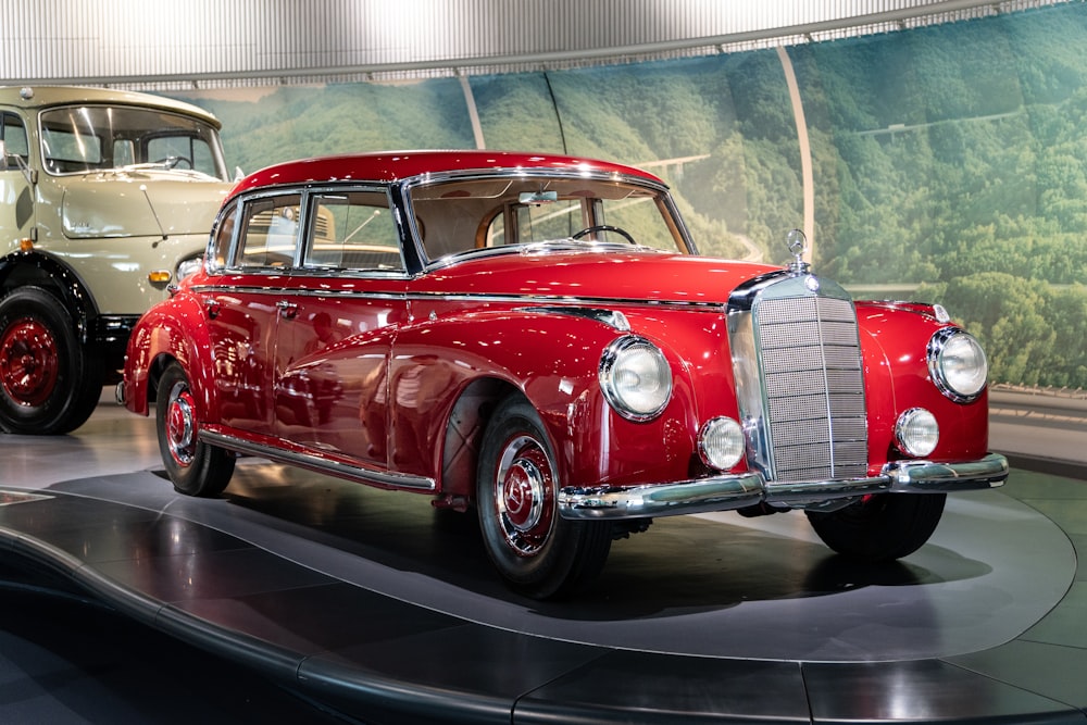 a red and white car on display in a museum