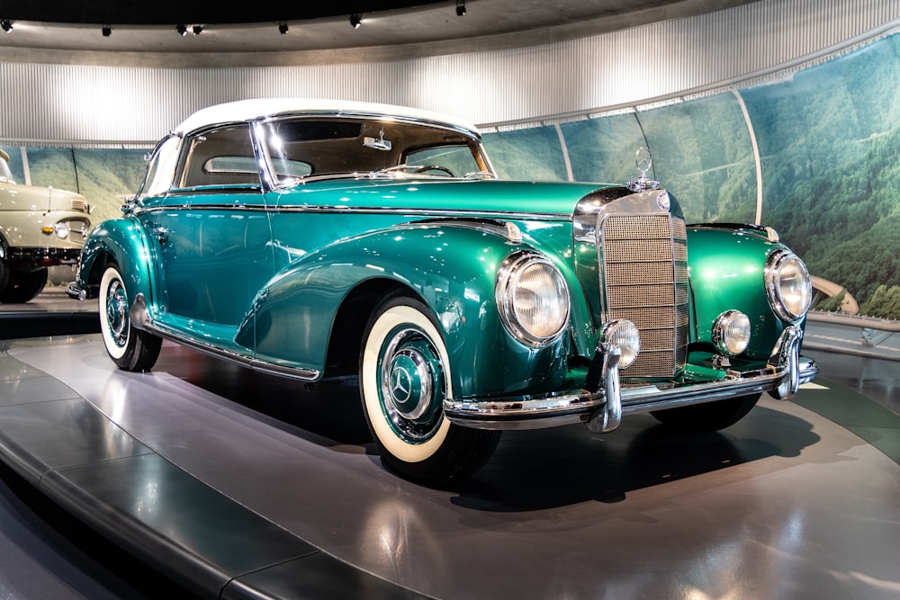 a green car is on display in a museum