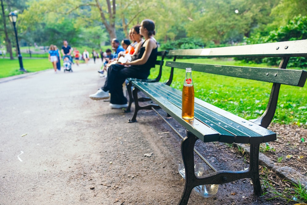 a group of people sitting on a park bench