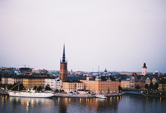 A serene luxury travel scene with a calm European cityscape at dusk, highlighting exclusivity and peace.