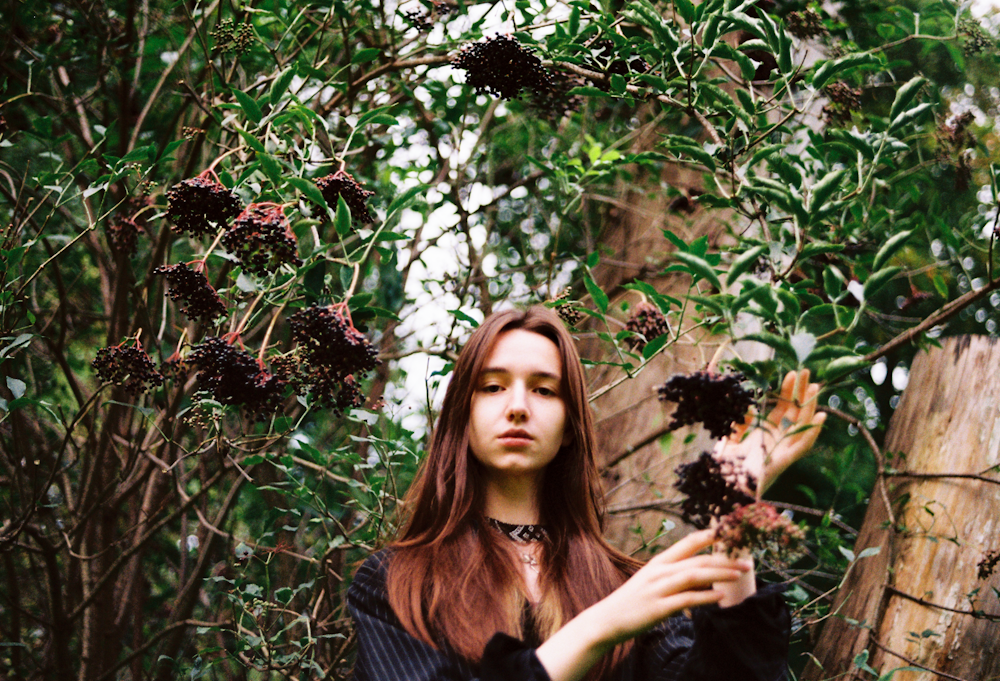 a woman holding a bunch of flowers in her hands