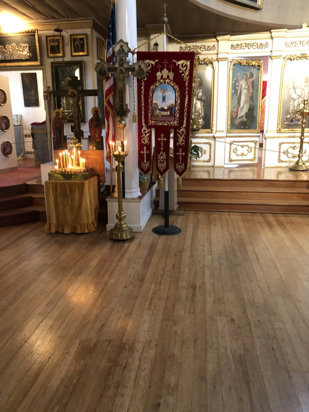 a church with a wooden floor and a large alter