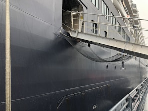 Wide shot of Riviera Yacht Logistics hangar entrance with security features visible