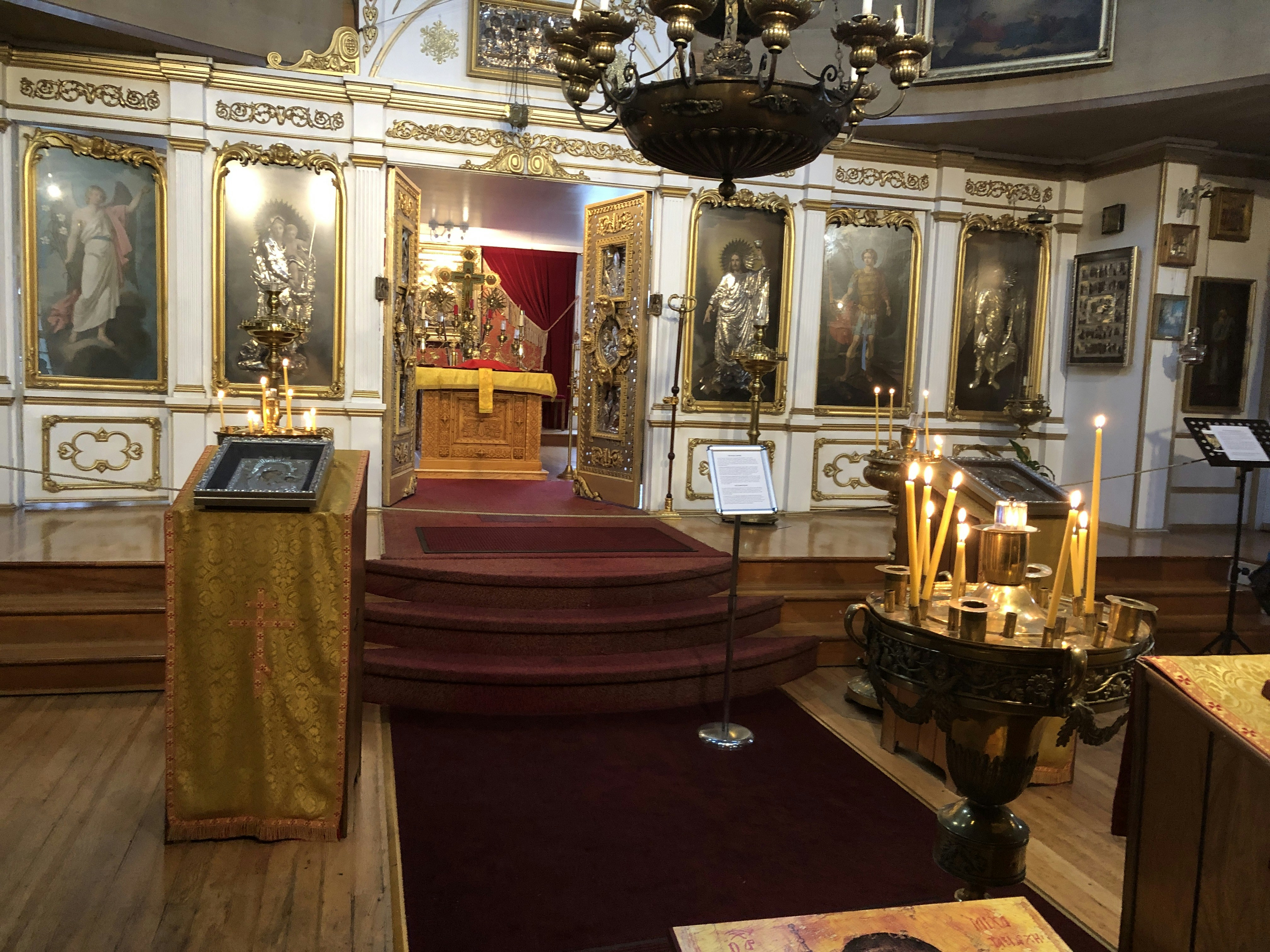 a church with a red carpet and a chandelier